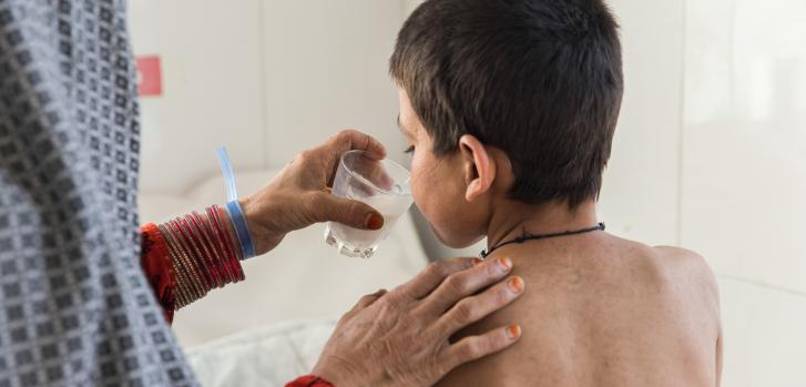 Saed Bibi le da un vaso de leche a su hijo Saddiqulah, de 10 años, en el departamento de pediatría del hospital Boost.Oriana Zerah.