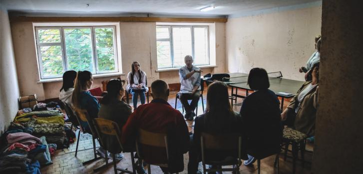 Personas desplazadas internamente desde el este de Ucrania atienden una sesión de psicoeducación facilitada por Ihor Ohdansky, un psicólogo de nuestra organización, en la ciudad de Ivano-Frankivsk.Igor Barbero.