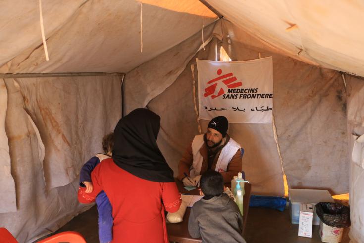 Enfermero registra a una familia en la clínica móvil instalada en la zona de Al-Dana.