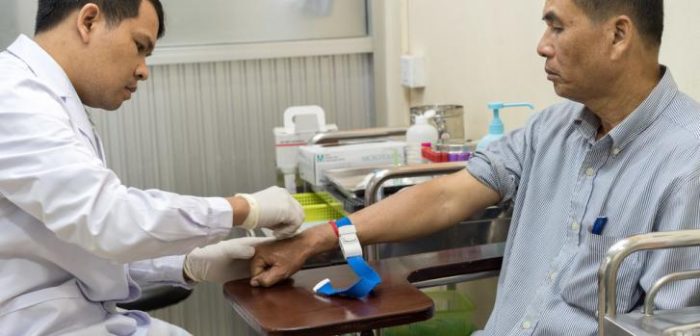 Din Savorn, de 50 años, recibe un análisis de sangre por parte de un técnico de laboratorio en la clínica de MSF Hepatitis C en el Hospital Preah Kossamak en Phnom Penh, Camboya, 20 de abril de 2017. ©Todd Brown/MSF