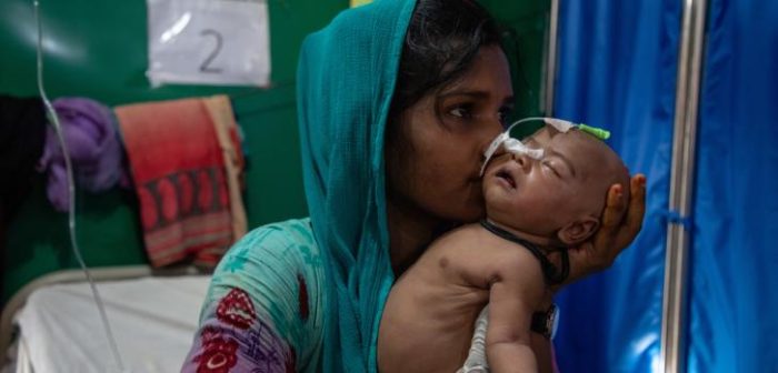 Romana Aktes, de 17 años, usa un guante médico como chupete improvisado para consolar a su bebé de 27 días, quien recibe tratamiento para una infección del tracto urinario en un hospital de MSF en Bangladesh.Daphne Tolis/MSF