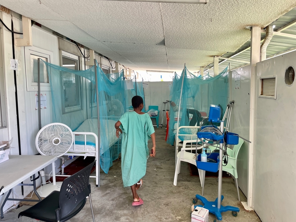 Un joven paciente de MSF está en un pasillo de hospital improvisado.