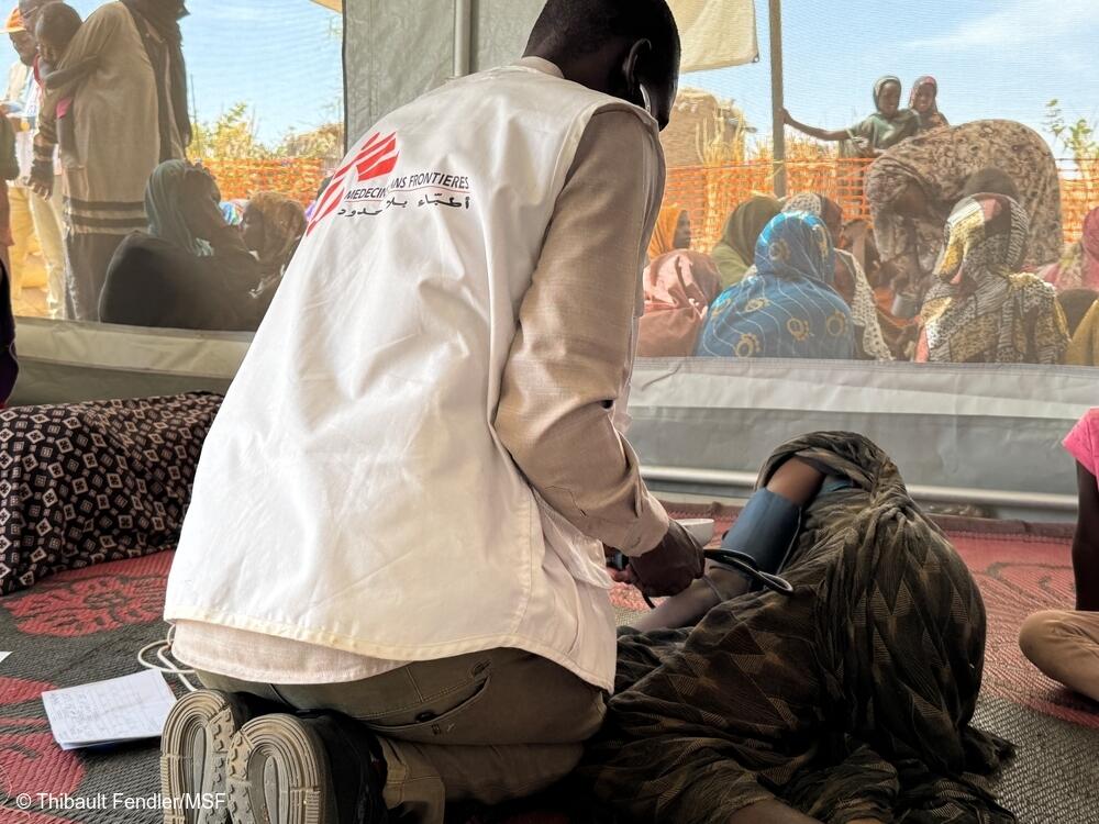 Hitham, enfermera de MSF, comprueba las constantes vitales de una anciana mientras se recupera en el puesto sanitario de MSF en Tawila Umda. En los últimos días, cientos de personas —mujeres, niños y ancianos— han sido traídas por sus familiares en estado avanzado de agotamiento y deshidratación.