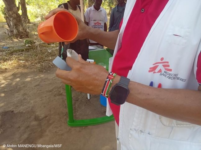 Un técnico de agua, higiene y saneamiento de MSF analiza la calidad del agua en un punto de cloración instalado por MSF en la aldea de Katanga, territorio de Fizi, Kivu del Sur, República Democrática del Congo.